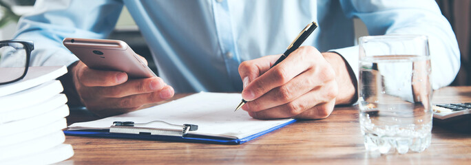 man  hand holding  phone with document