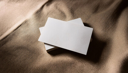 Fototapeta premium Blank business card mock up placed on soft textured linen fabric with ample copy space for personalization and design ideas, ideal for marketing professionals and creatives