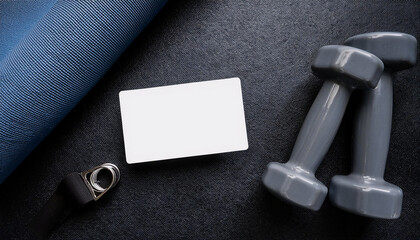Fitness coach business card mock-up on gym towel and dumbbells arranged for promotional display