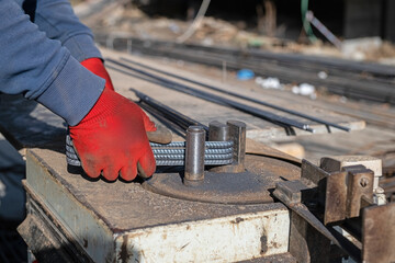 Ironworker preparing various sizes of iron for building construction.