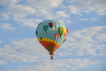 Bright Colorful Balloons in Morning Sky, Hot Air Balloon Fiesta, decorative balloons launching in blue fall sky in Albuquerque, New Mexico in October