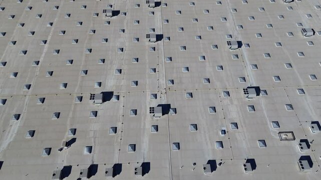 Commercial rooftop and packaged units RTU on flat roof large grocery store building in Irving, Texas, HVAC system contains all components to air conditioning, heating, proper ventilation, flyover