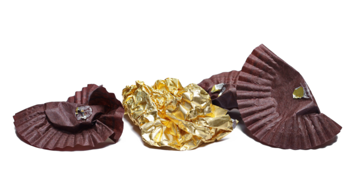 Crumpled, used chocolate wrapping trash, wrapper foil garbage for recycling isolated on white background
