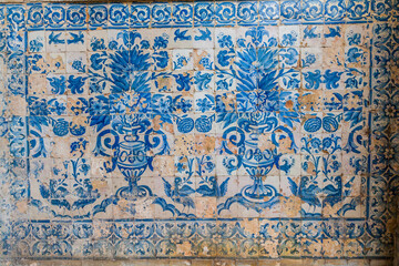 A vibrant blue and white tile mural depicting floral motifs and birds © wundermann