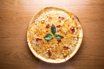 Classic Margherita Pizza topped with tomato sauce, mozzarella cheese, and basil leaves served on wooden board isolated on table background top view of italian cousin