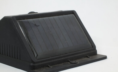 A mini solar panel on a white background. A mini solar panel that can be used to charge portable devices, such as mobile phones, tablets, power banks, or LED lights.