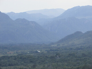 A beautiful view from the top of Serra do Cipó of a rain coming in the distance high in the mountains