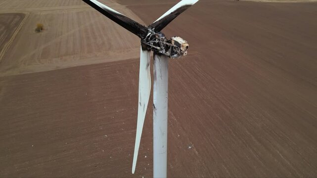 Close up footage of a burned down wind turbine generator. Lightning strike of windmill or overheating caused meltdown of power generator engine and mechanical system. Destroyed infrastructure Disaster
