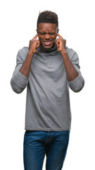 Young african american man over isolated background covering ears with fingers with annoyed expression for the noise of loud music. Deaf concept.