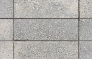 Straight on view of a wall made of grey concrete block
