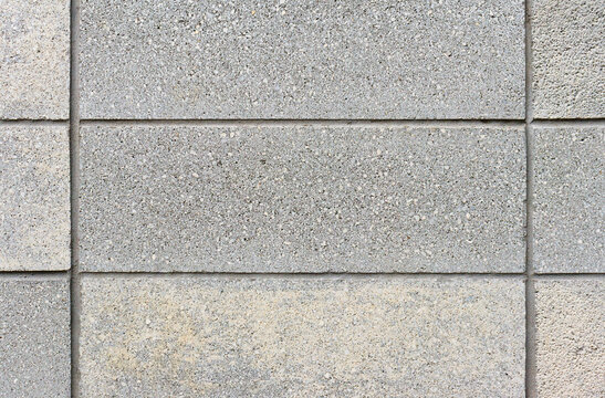 Straight on view of a wall made of grey concrete block