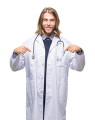 Young handsome doctor man with long hair over isolated background looking confident with smile on face, pointing oneself with fingers proud and happy.