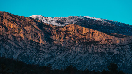 Golden Hour View of Majestic Mountain in Southern Croatia with Snow-Capped Peaks