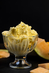 sweet creamy ice cream and pieces of melon on the table