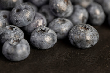 a pile of blueberries scattered on the board