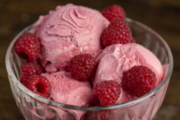 delicious sweet cold raspberry-flavored ice cream and ripe raspberries in a glass