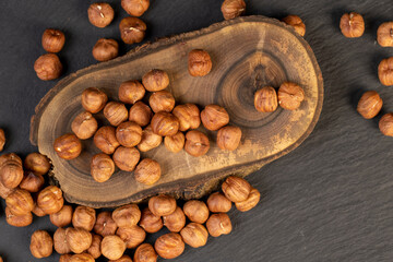 peeled raw hazelnuts on a table and a board