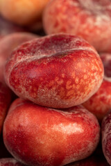 a pile of ripe washed peaches on the table
