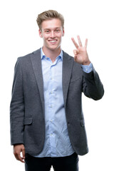 Young handsome blond business man showing and pointing up with fingers number three while smiling confident and happy.