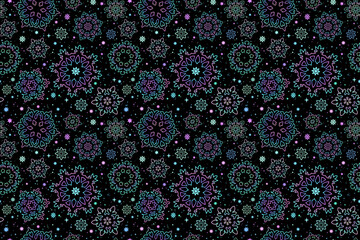 Abstract flying painted snowflakes on black background