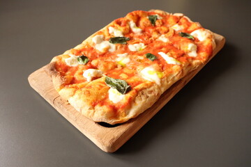 Indulge in this Delicious Homemade Margherita Pizza beautifully presented on a Wooden Board