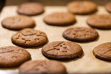 Oven tray with fresh hot gingerbread cookies, traditional Christmas recipe. aroma and taste of new year holidays