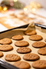Oven tray with fresh hot gingerbread cookies, traditional Christmas recipe. a tray of cookies with a Christmas design on them