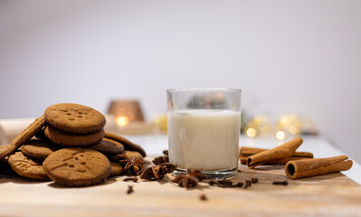 homemade gingerbread cookies with a glass of milk and spices: anise, cloves and cinnamon....
