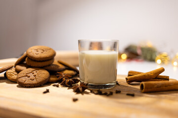 homemade gingerbread cookies with a glass of milk and spices: anise, cloves and cinnamon. traditional christmas dessert, christmas and new year celebration