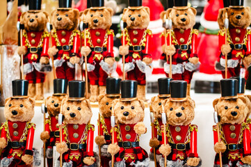 Christmas soldier teddy bears lined up in a row, on a blurred background