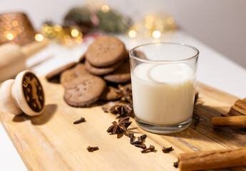 homemade gingerbread cookies with a glass of milk and spices: anise, cloves and cinnamon. traditional christmas dessert, christmas and new year celebration