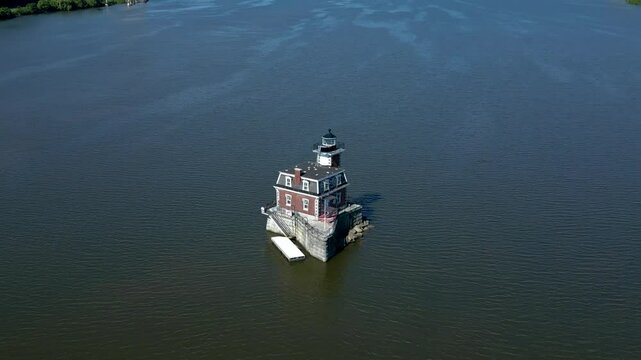 Historic New York lighthouse with mountains in the background, drone 4K