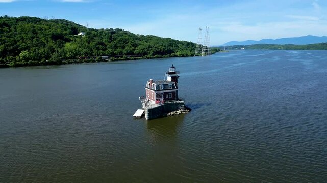 Historic New York lighthouse with mountains in the background, drone 4K