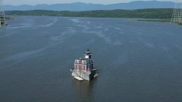 Historic New York lighthouse with mountains in the background, drone 4K