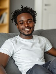 Positive, Confident Young Man Sitting on a Sofa