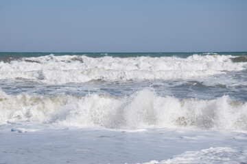View of the sea waves with white foam.