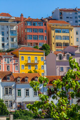 A vibrant cityscape with colorful houses and red tiled roofs, showcasing the charming architecture of Coimbra