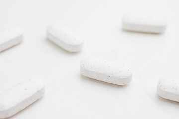 White supplement pills close up. Dietary supplement. Alternative medicine.