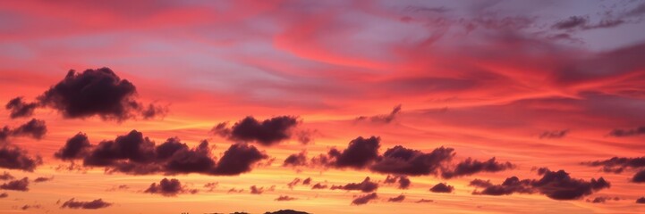 Colorful and dynamic sky with swirling clouds at sunset, twilight, dramatic, dusk