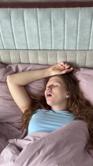 beautiful young woman snoring in her sleep in bed, concept apnea, snoring, disorder