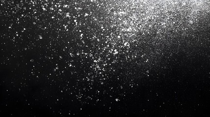 Obraz premium White particles dispersed on a black background