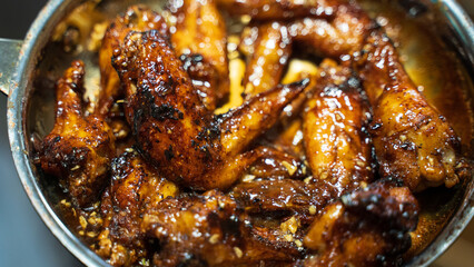 Canh ga chien nuoc mam or fried chicken with fish sauce, Vietnamese cuisine. A typical home cook meal for your loved ones. Chicken wings are fried then mixed with fish sauce, garlic. Top on plain rice