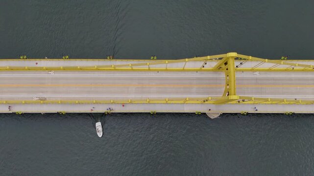 Explore the architectural beauty of Pittsburgh with this drone footage over the 6th Street Bridge. The camera offers a direct top-down view, panning across the intricate structure of the bridge.