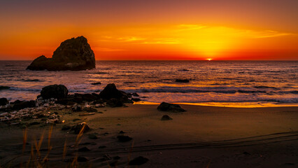 Sunset over the California Coast ate the rock formation called Hunter Rock near Crescent City.