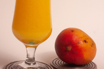 glass of mango juice with colorful mixers