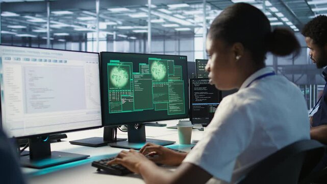 Admin in server hub trying to protect gear from hacker attack stealing sensitive information. Data center employee struggling to erase virus after seeing security breach alert on monitor, camera A