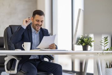 Excited Businessman Celebrating Success in Modern Office Environment