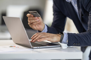 Businessman Making Online Payment With Credit Card and Laptop
