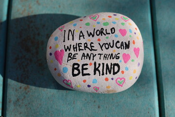 Hand painted kindness rock saying in a world where you can be anything be kind