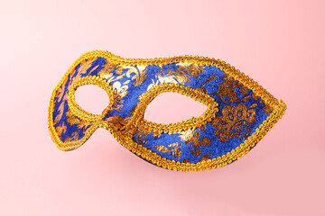 Beautiful bright carnival mask on pink background